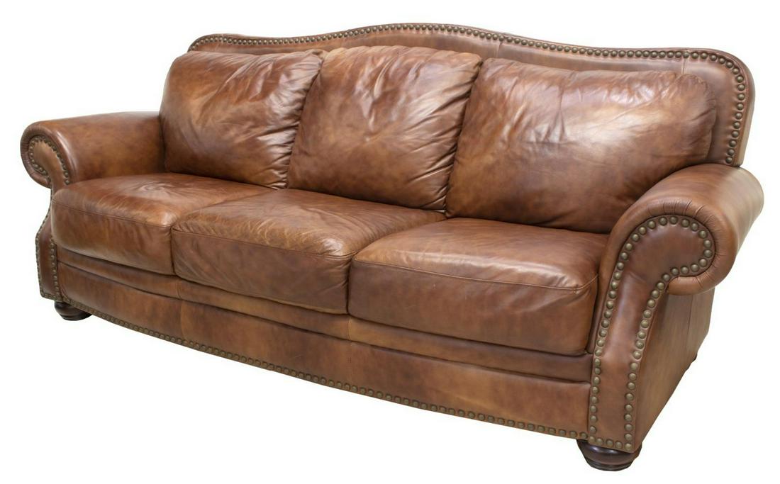 CONTEMPORARY BROWN LEATHER THREE SEAT SOFA: Contemporary brown leather three seat sofa, rolled arms with large nail head accents, all rising on bun feet, approx 38"h, 89.25"w, 33"d Start Price: $300.00
