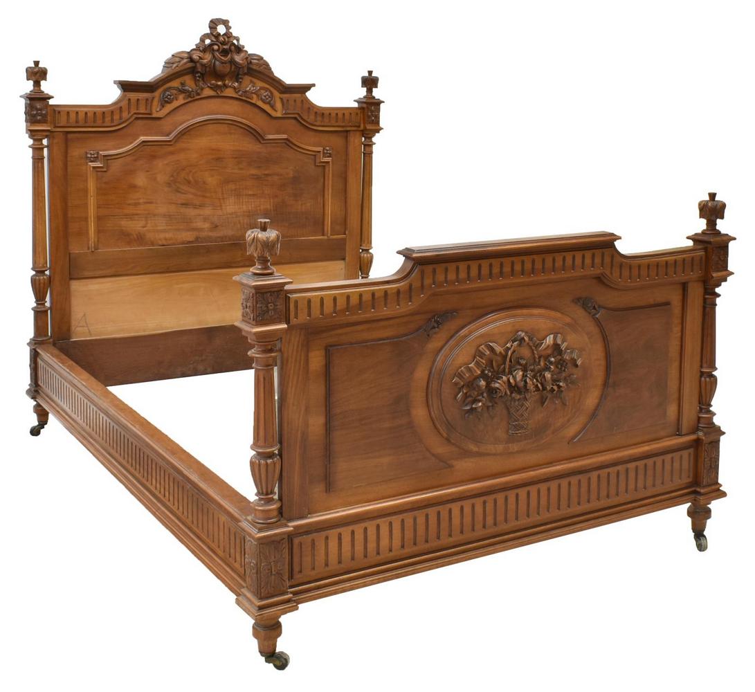 FRENCH LOUIS XVI STYLE WALNUT BED: French Louis XVI style walnut bed, late 19th c., having ribbon crest flanked by foliate carved finials at head and footboard, flanked by fluted columns, headboard with center carved ribbon, florals an