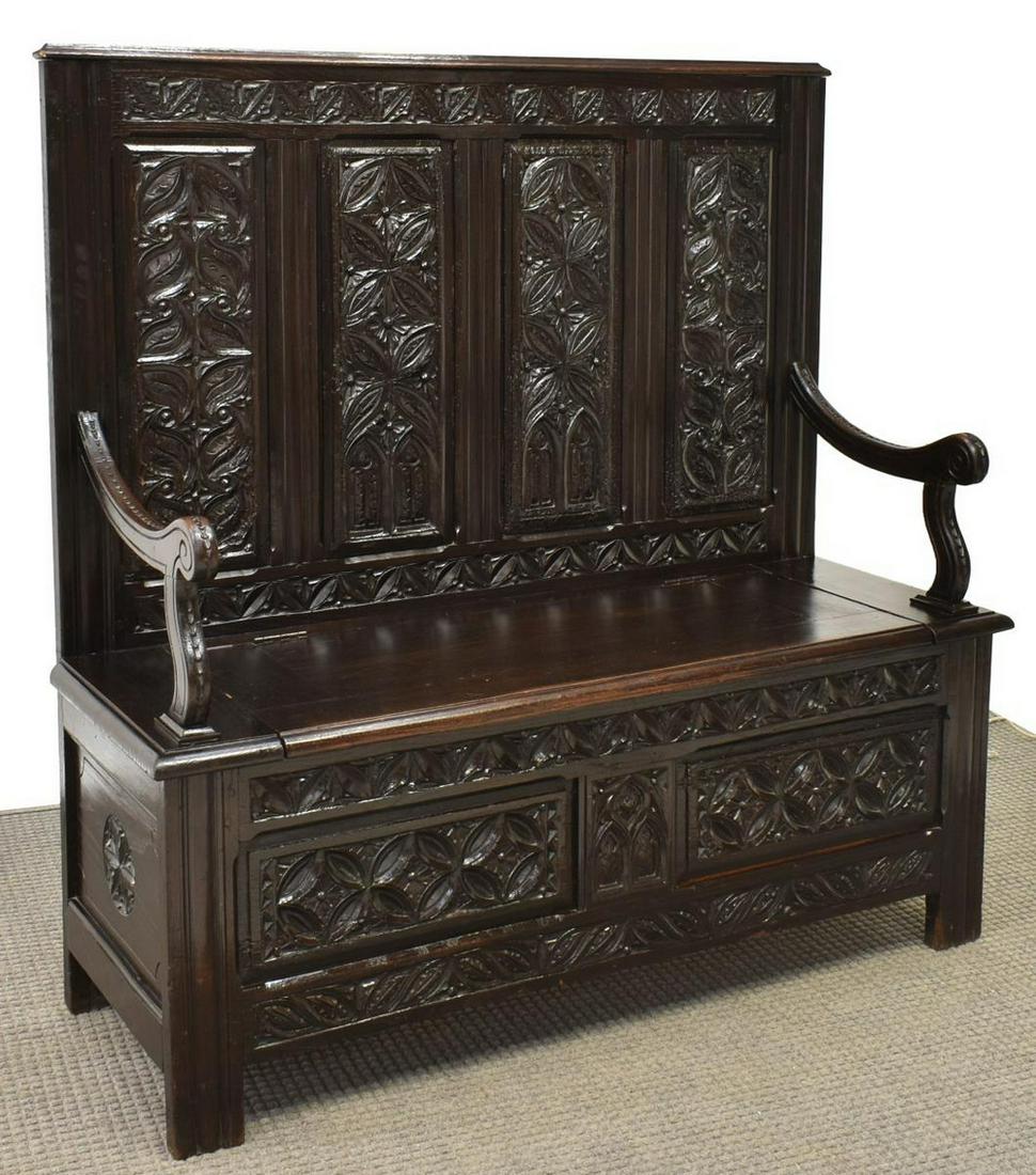 FRENCH BRETON CARVED OAK HALL BENCH: French carved oak hall bench, Brest, Brittany, early 20th c., paneled back with geometric and Gothic revival tracery patterns in relief, hinged bench seat, carved paneled base, hand-written label at b