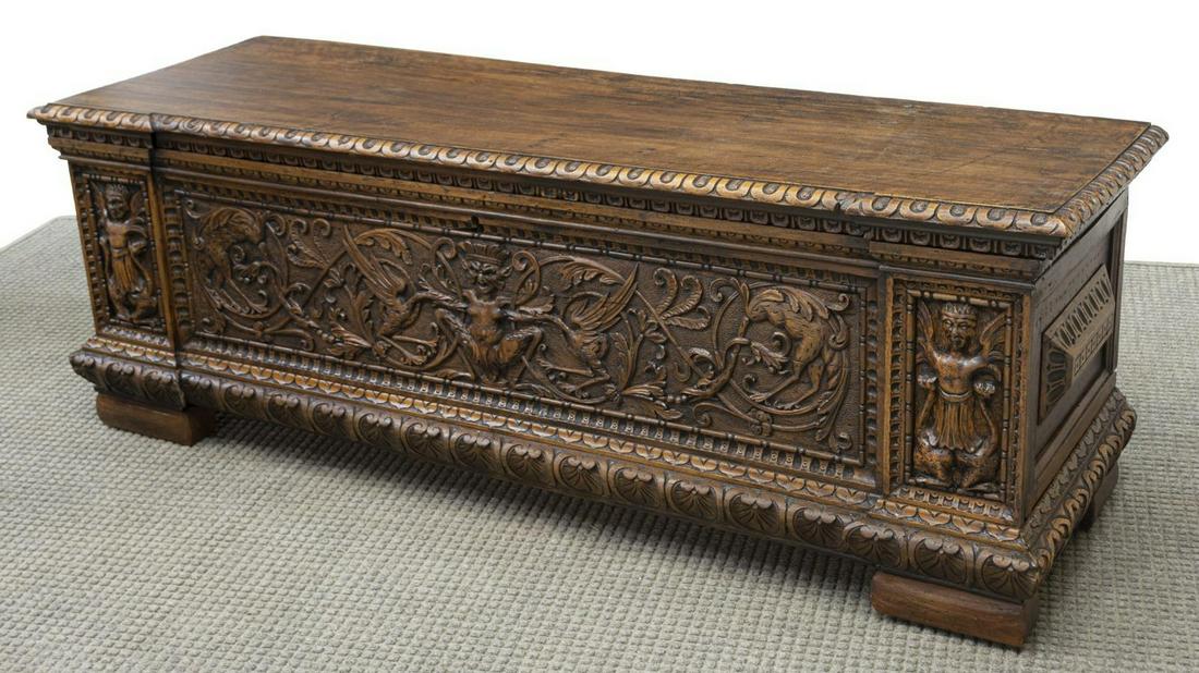ITALIAN RENAISSANCE REVIVAL CASSONE CHEST: Italian Renaissance Revival mixed wood cassone/ chest, rectangular case with hinged top on iron strap hinges, interior till with carved lid, front panel carved with grotesques and masks, molded base r