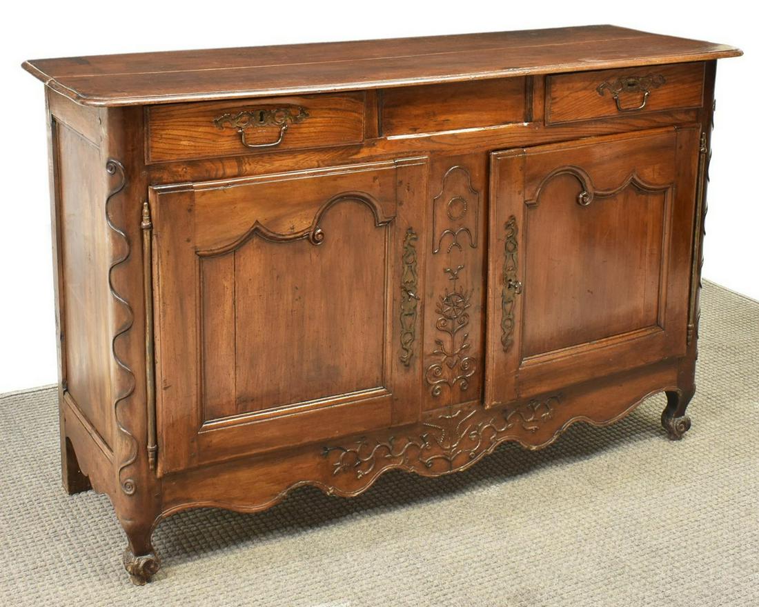 FRENCH LOUIS XV ELM & WALNUT SIDEBOARD, 18TH C.: French Louis XV elm and walnut sideboard, c.1770, accented with foliate and geometric carving, the rectangular top over two drawers above two doors hung on exterior hinges, a shaped skirt, all rising