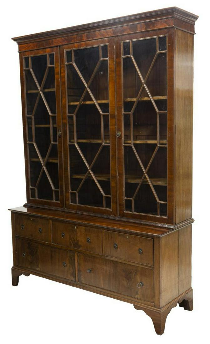 ENGLISH GEORGIAN STYLE MAHOGANY STEPBACK BOOKCASE: English Georgian style mahogany stepback bookcase, early 20th c., cornice top, over three astragal glazed doors, interior shelves, lower case fitted with five drawers, rising on bracket feet, approx 8