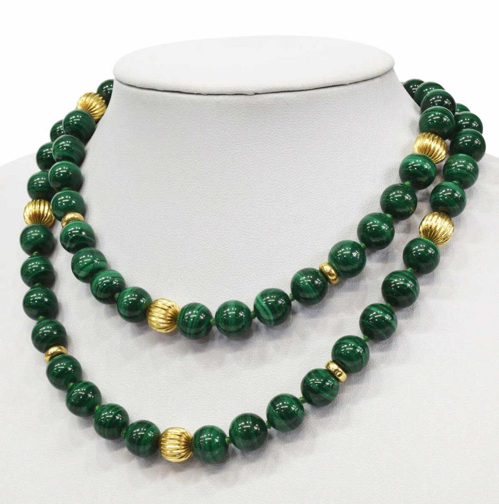 ESTATE 14KT GOLD & MALACHITE BEADED NECKLACE: Estate malachite beaded necklace, spaced by ribbed hollow 14kt gold beads (tested), marked 14kt on clasp, one gold bead misshapen, approx 30"l, 132.8 grams (inclusive of all material) *Provenance: The