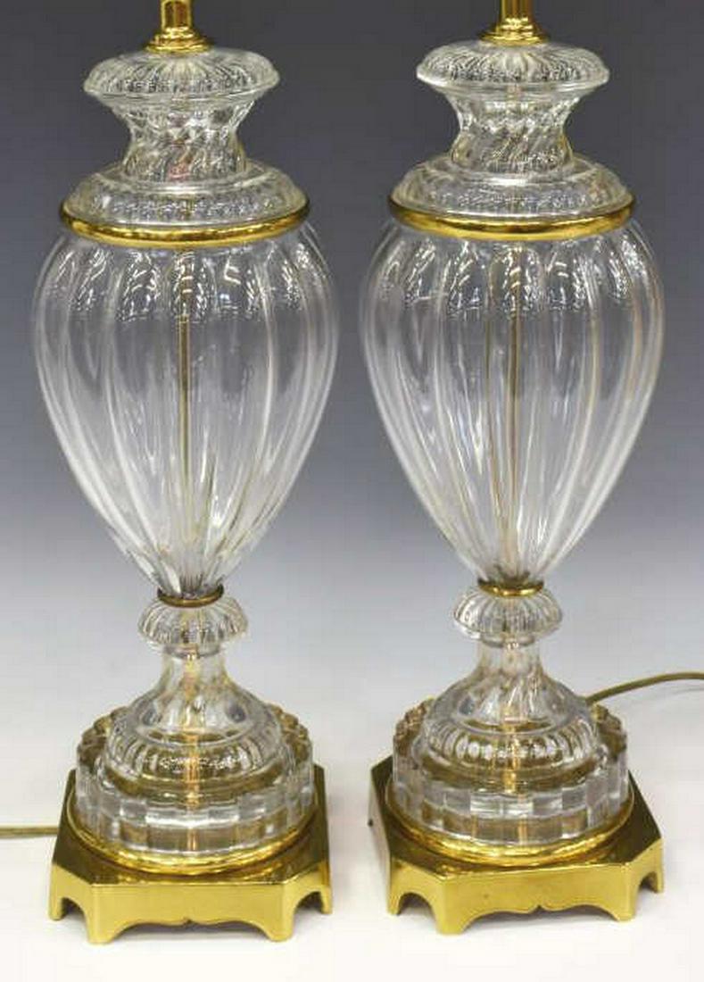 (2) PAUL HANSON PRESSED GLASS 1-LIGHT TABLE LAMPS: (pair) Paul Hanson pressed glass single-light table lamps, 20th c., having a single light atop a spiraled and reeded glass standard, brass band accents, resting on square base with eight feet, each ma