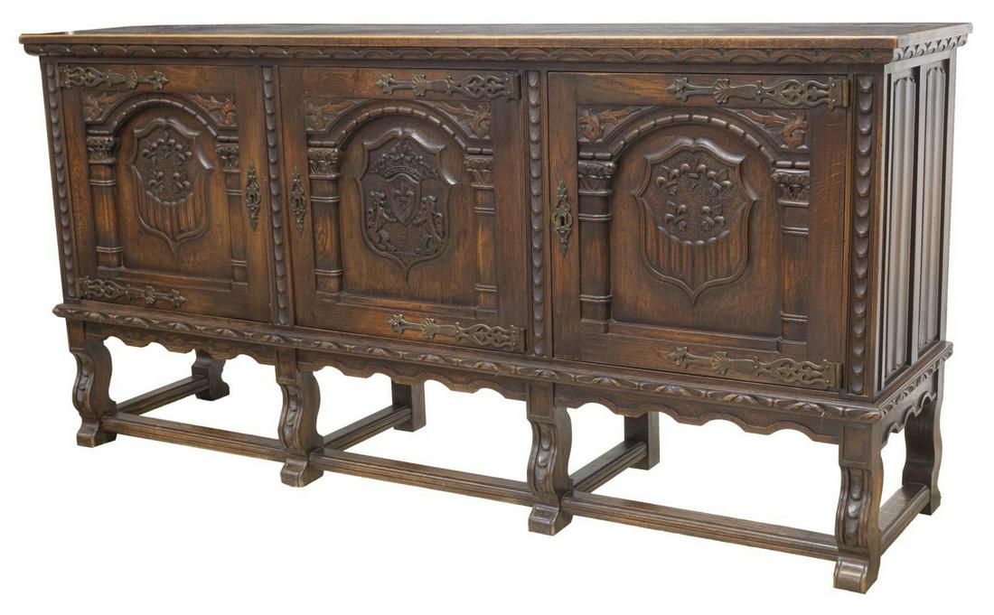 FRENCH RENAISSANCE REVIVAL CARVED OAK SIDEBOARD: French Renaissance Revival finely carved oak sideboard, late 19th c., having parquetry top, above rectangular case with linen fold panels to each side, three carved doors, featuring fleur-de-lis and c