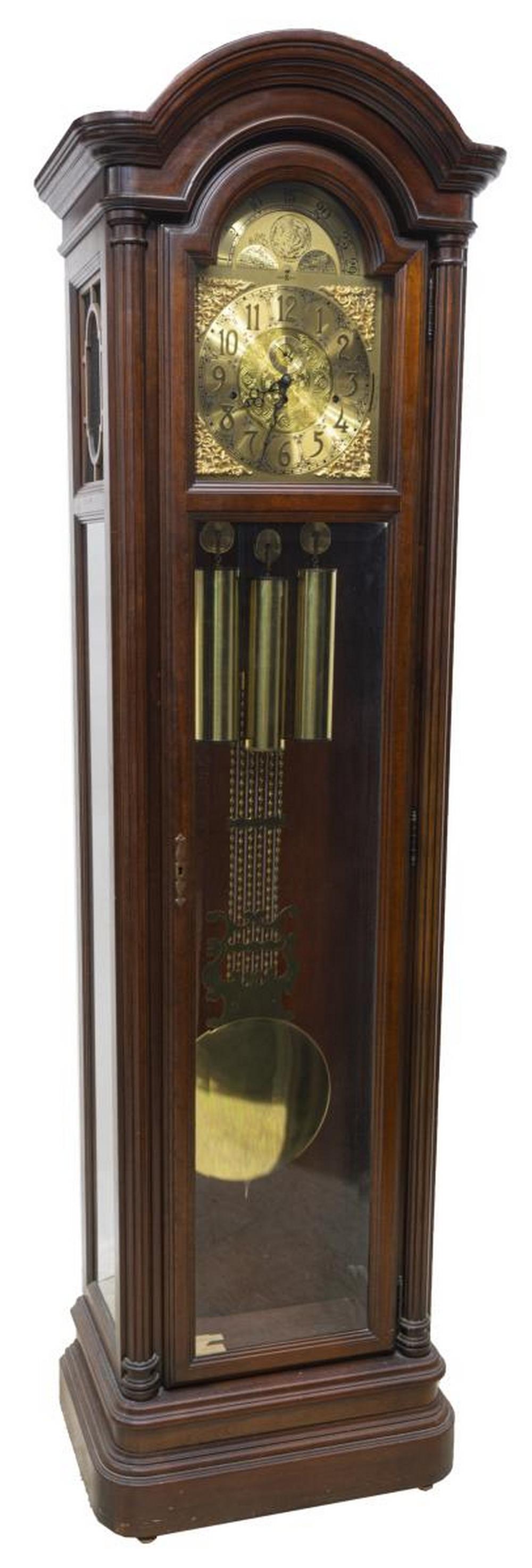 HOWARD MILLER TRIPLE CHIME STANDING LONGCASE CLOCK: Mahogany longcase clock, last quarter 20th c., Howard Miller Clock Company, model no. 610-152, movement by Kieninger, Germany, standing case in a mahogany finish, fluted engaged columns, glazed dial a
