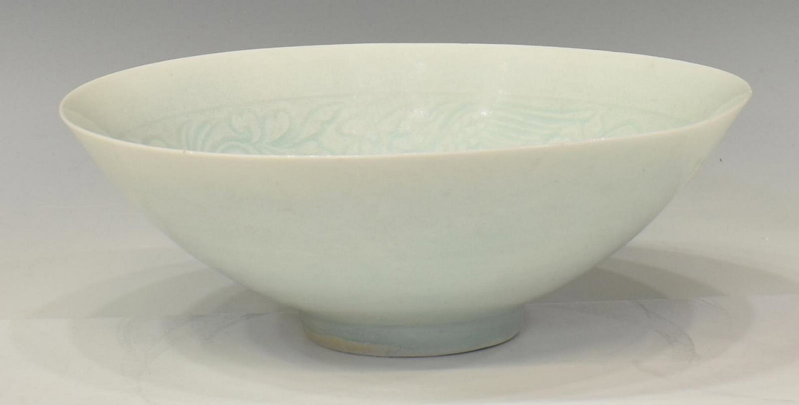 KOREAN CELADON BOWL, c.1930s: Celadon translucent bowl, believed to be Korean, c.1930s, the interior with foliate and bird motif, some roughness at edge, approx 2.5"h, 7.5"diam, 0.35lbs Start Price: $80.00