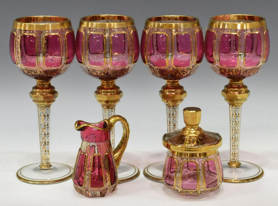 (6) BOHEMIAN MOSER STYLE ART GLASS STEMWARE, ETC.: (lot of 6) Bohemian Moser style cranberry art glass stemware and service items, comprising: (4) cranberry and gold gilt stemmed wine goblets, approx 8.25"h, 3.25"diam; (1) creamer with applied gold ha
