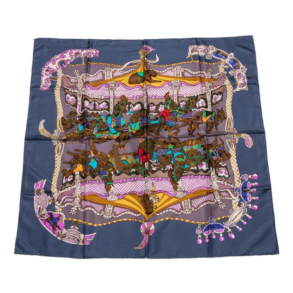 HERMES SILK TWILL SCARF, 'TOURNEZ MANEGE': Hermes silk twill scarf, "Tournez Manege" pattern, original design by Annie Faivre, grey-blue ground with purple, gold, grey, and yellow motif, measurements for shipping purposes only - approx: 35"l, 