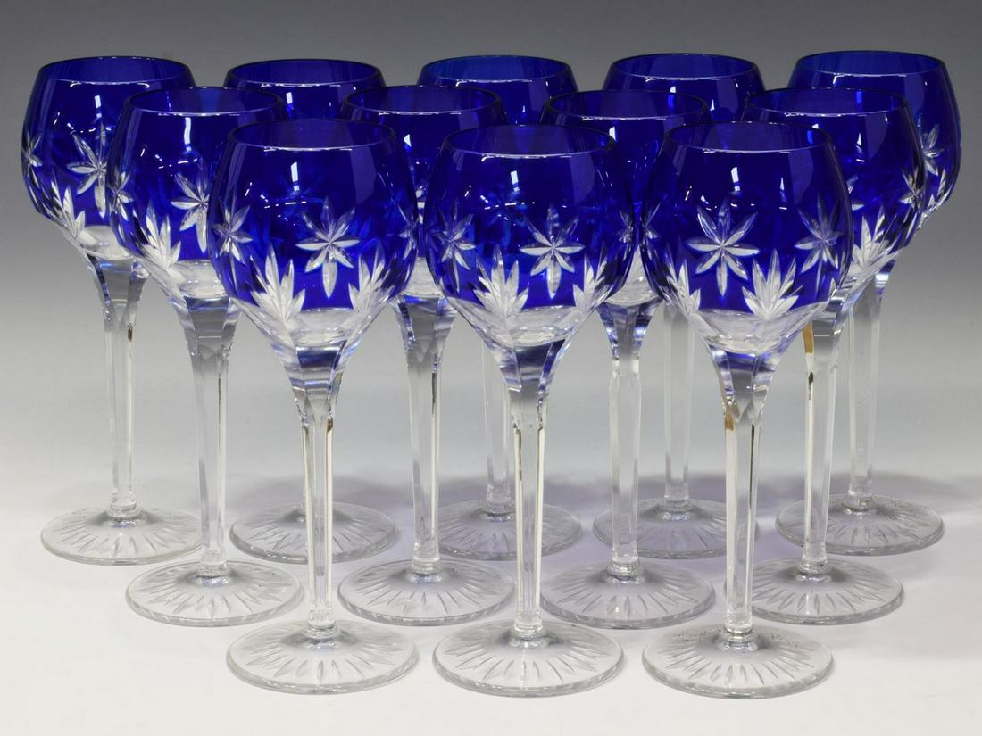 (12) BLEIKRISTALL COBALT CUT-TO-CLEAR WINE STEMS: (lot of 12) Nachtmann Bleikristall cobalt cut-to-clear glass wine stems, having star motifs, each bearing acid etched mark "Germany HB 83FC" underfoot, approx 8.25"h, 3.25"diam; 7.75lbs total Start Pr