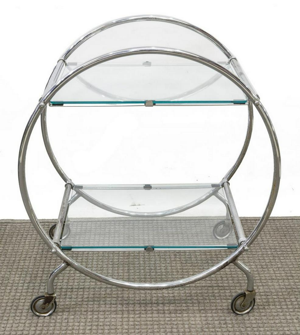 MID-CENTURY MODERN CHROMED STEEL SERVICE CART: Mid-century modern chromed steel service cart / tea trolley, c.1950s-1960s, two glass shelves, on chrome stretchers, circular hoops on sides provide additional structural support, on casters, approx 3