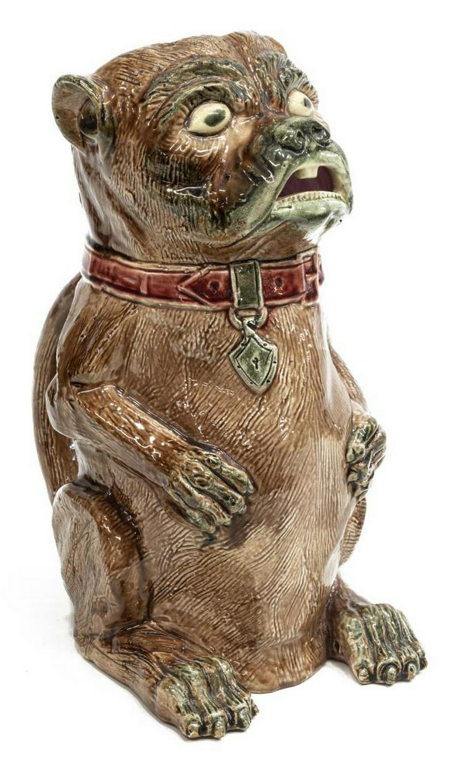 EUROPEAN MAJOLICA DOG FORM PITCHER: European majolica dog form pitcher, in an all-over brown glaze, detailed snout, teeth and paws, with attached handle to back, approx 10.5"h, 5"w, 8"d, 2.5lbs Start Price: $50.00