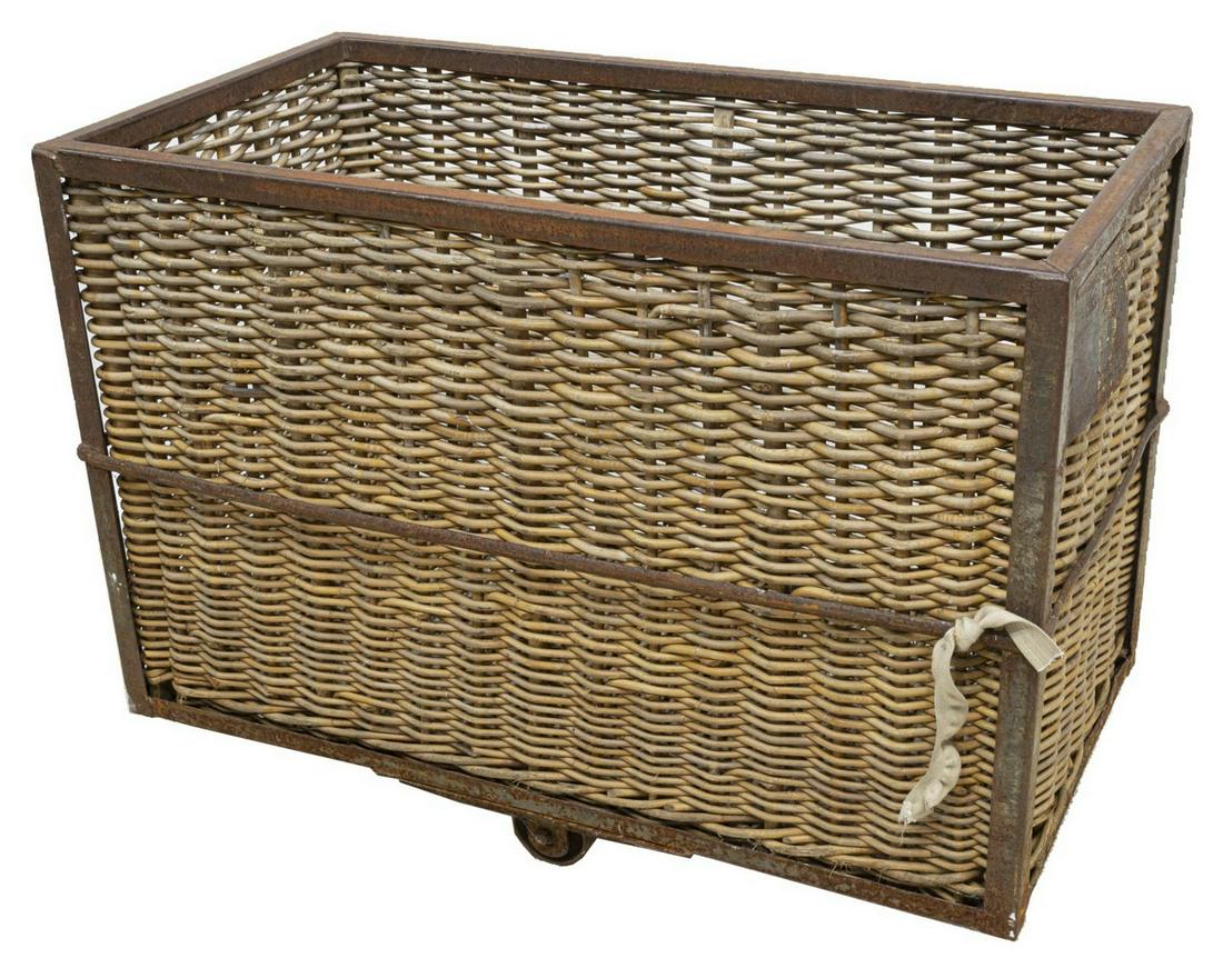 FRENCH WICKER & IRON INDUSTURIAL CART: French wicker and iron industrial cart, early 20th c., large cart with woven wicker interior and exterior, encased in iron frame, fitted with two wheels, oxidation to iron as pictured, approx 32"h, 43