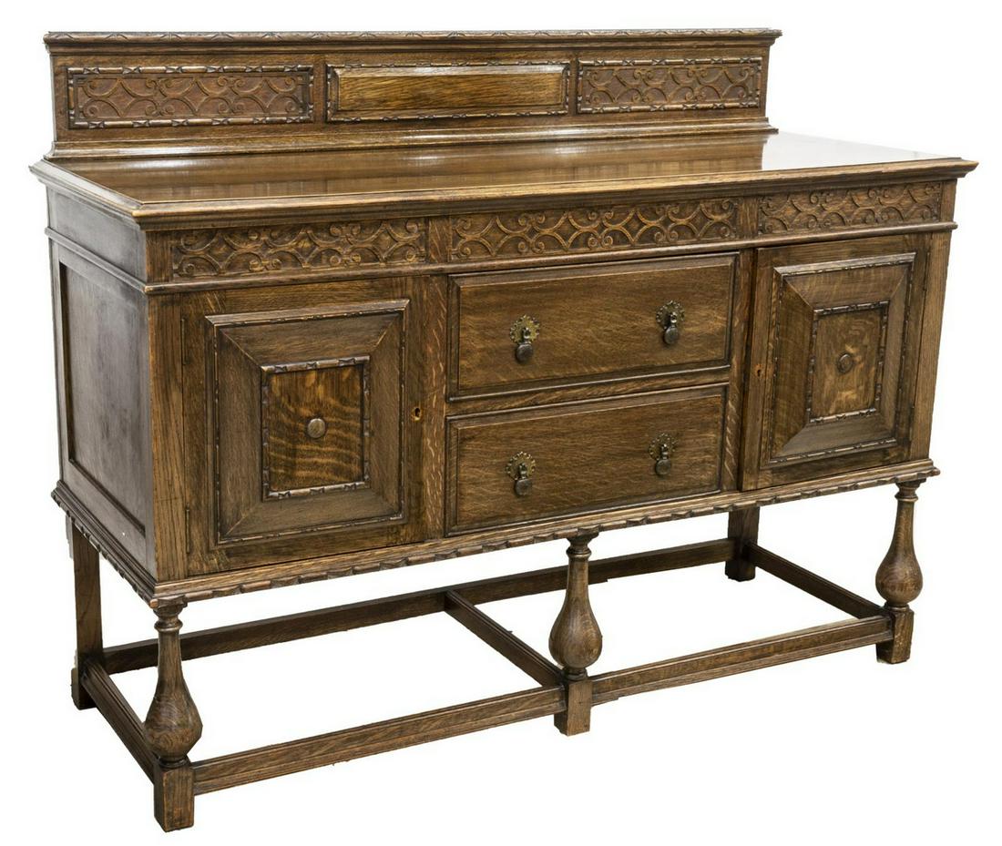 ENGLISH TUDOR STYLE CARVED OAK SIDEBOARD: English Tudor style oak sideboard, mid 20th c., carved gallery back, over rectangular case, two centered drawers flanked by side cabinets, left side with interior shelf, right side with divided cellar