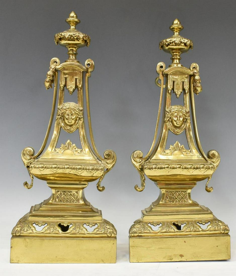 (2) FRENCH GILT METAL CHENETS ANDIRONS: (lot of 2) French gilt metal chenets, 19th c., finial over flared standard, central mask, bellflower ring handle, stepped base with pierced trefoils, approx 18"h, 7"w, 5"d; 12lbs total Start Price: $1