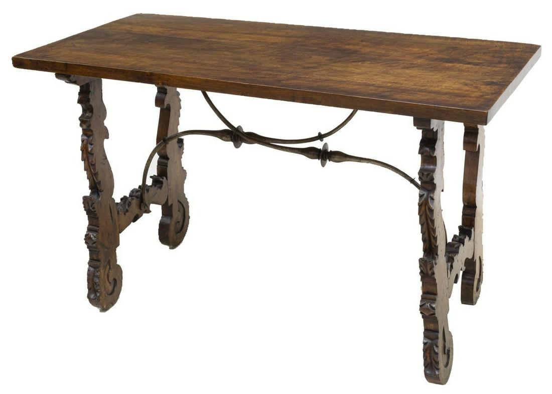 SPANISH BAROQUE STYLE WALNUT TABLE: Spanish Baroque style walnut table, 20th c., rectangular top above trestle base, joined by scrolled iron stretcher, approx 30"h, 49.25"w, 24"d Start Price: $200.00