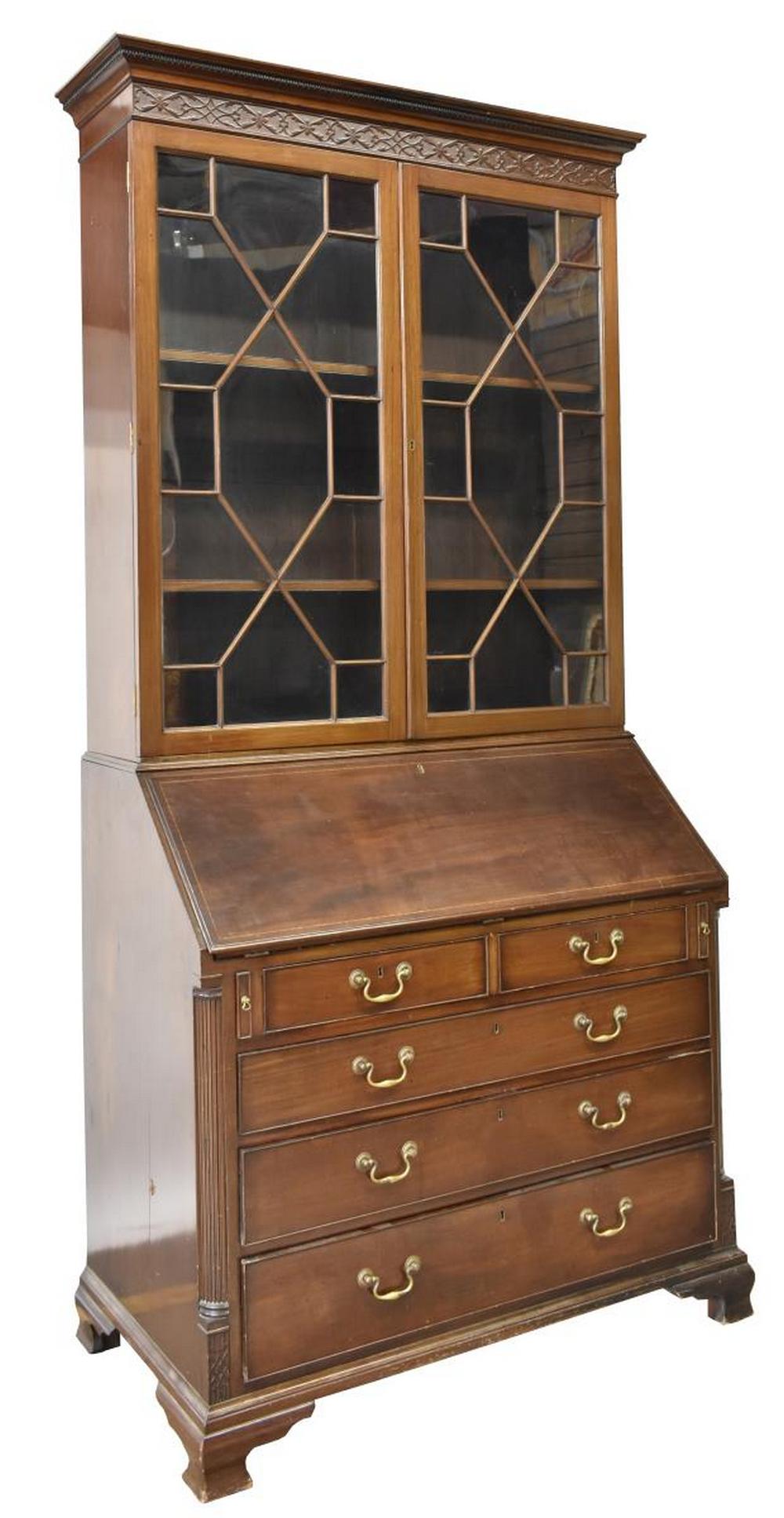 ENGLISH GEORGIAN STYLE MAHOGANY SECRETARY BOOKCASE: English Georgian style mahogany secretary bookcase, early 20th c., cornice top over blind carved frieze, astragal glazed double doors, over slant-front desk opening in fitted interior gallery with sma