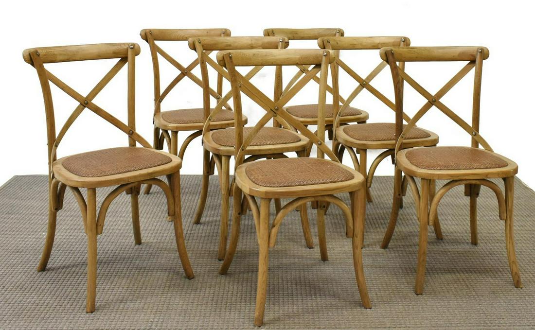 (7) THONET STYLE BENTWOOD CROSS BACK BISTRO CHAIRS: (lot of 7) Thonet style chairs, late 20th c., oak frames, bentwood back with cross bracing, over inset woven rattan seat, rising on slightly outswept legs, approx 35"h, 18"w, 18.5"d Start Price: $250.
