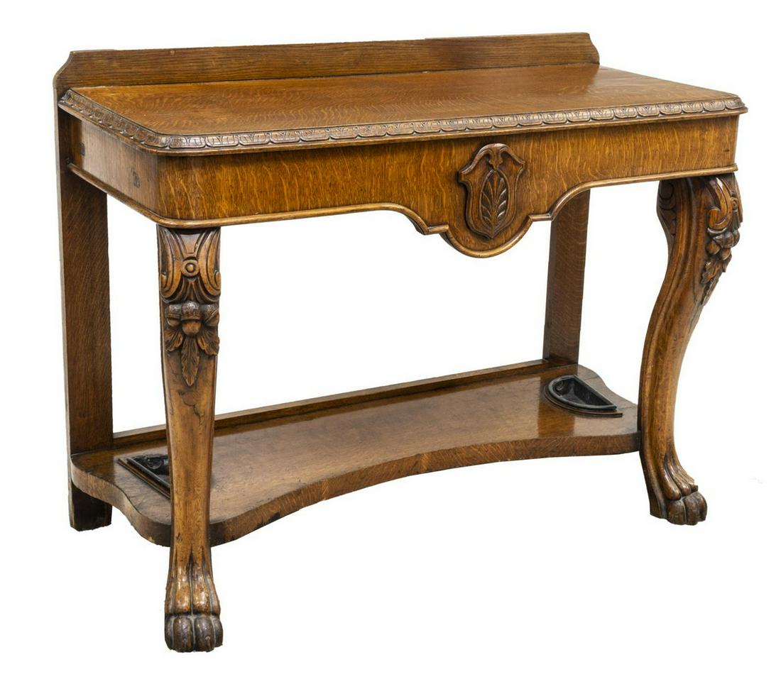 ENGLISH VICTORIAN CARVED OAK CONSOLE TABLE: English Victorian oak console table, mid to late 19th c., raised gallery back, over rectangular top with molded edge, rising on cabriole legs carved with acorns and oak leaves, joined by medial shelf 