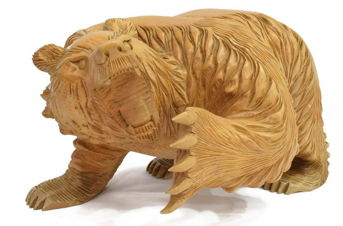 BLACK FOREST STYLE CARVED WOOD MODEL OF A BEAR: Carved wood model of a walking bear, 20th c., open mouth and raised paw, some loss to teeth, stylized mark underfoot, approx 8"h, 12"l, 9.5"d, 7.25lbs Start Price: $60.00