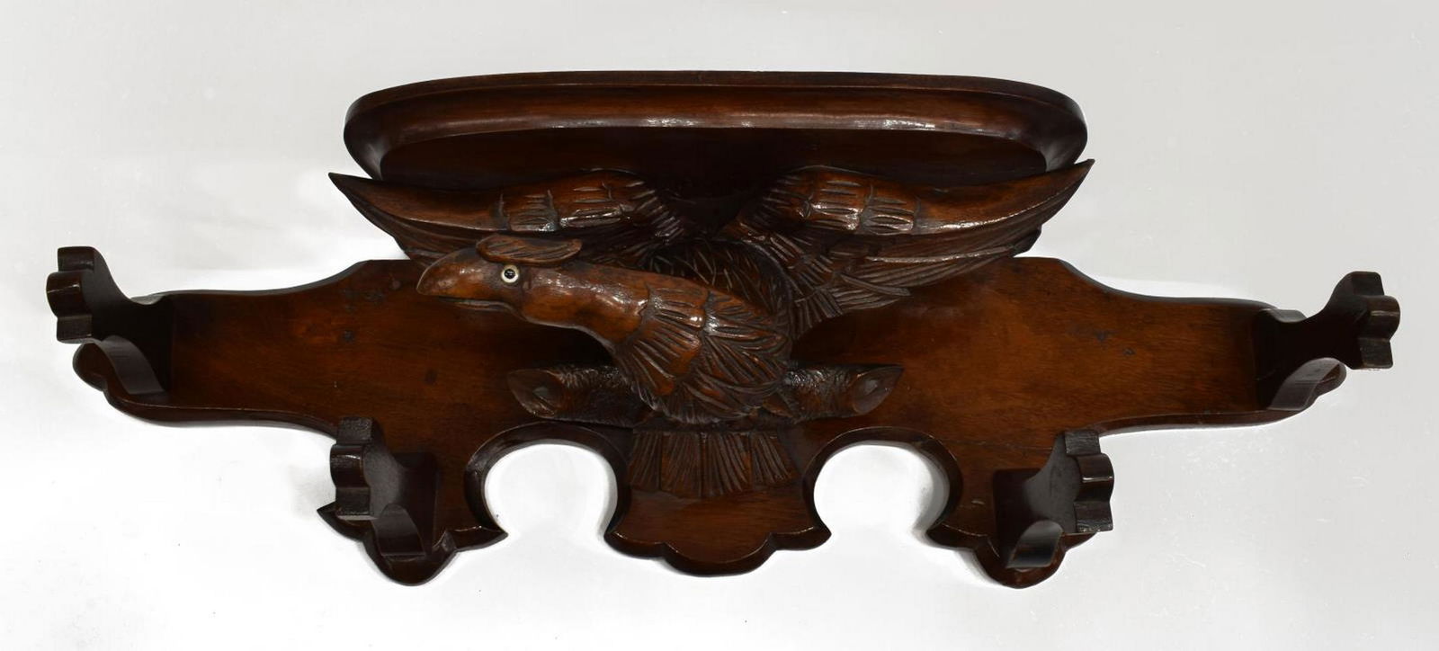 LATE VICTORIAN MAHOGANY CARVED EAGLE COAT RACK: English Late Victorian mahogany coat rack/ wall bracket, early 20th c., demilune shelf supported by carved eagle with inset eye, shaped backboard issuing four hooks, restoration, approx 8.5"h, 27.25"w