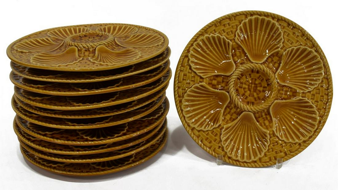(11) FRENCH LONGCHAMP FAIENCE OYSTER PLATES: (lot of 11) French faience oyster plates, Longchamp, mid 20th c., in an ochre/ brown glaze, with six scallop shell shaped wells, against ground with embossed basket weave pattern, marked underfoot, ap
