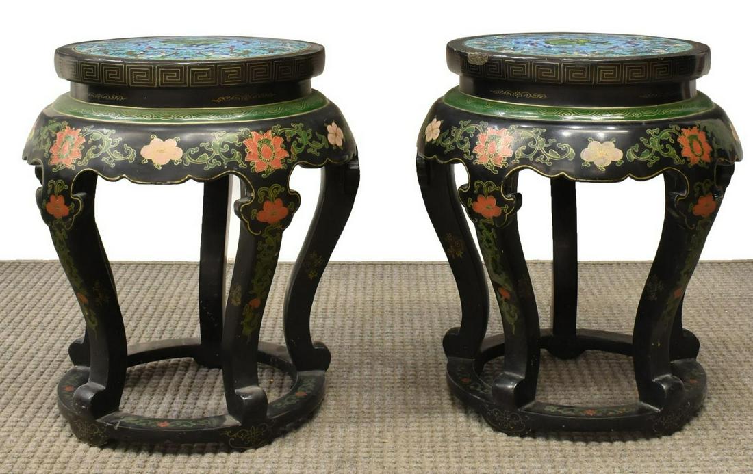 (2) CHINESE CLOISONNE-TOP GARDEN STOOLS: (lot of 2) Chinese garden stools, 20th c., inset cloisonne enamel top with phoenix border, over black lacquer frame with Greek key, stylized clouds, and lotus motifs, scrolled legs joined by ring base