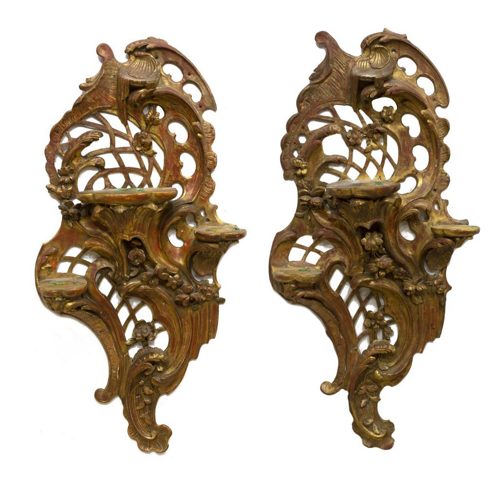 (2) FRENCH LOUIS XV STYLE GILTWOOD WALL BRACKETS: (pair) Large French Louis XV style giltwood wall brackets, 19th c., three staggered height shelves, over the reticulated back, accented with floral and shell decoration, approx 40"h, 19.75"w, 6"d; 14l