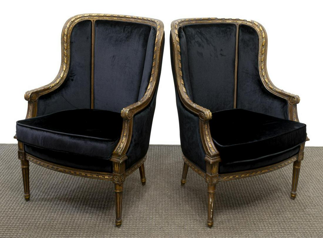 (PAIR) LOUIS XVI BLACK FABRIC, GILT FRAME BERGERES: (pair) Louis XVI style bergeres, 21st c., upholstered in black velvet with removable seat cushions, the craved parcel gilt frame descends to tapered ribbed legs, 40.5"h, 27"w, 22"d Start Price: $400.0