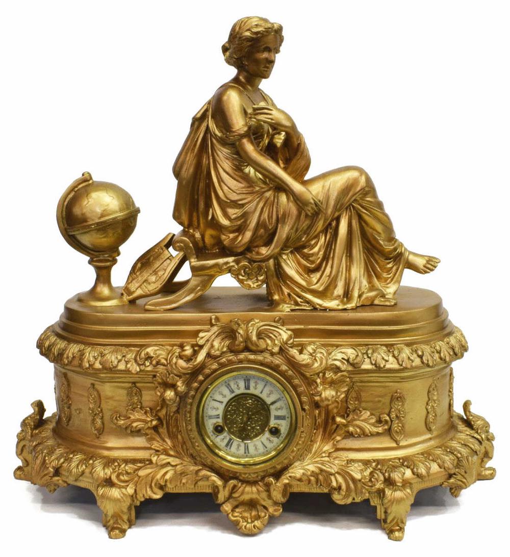 LARGE ORNATE GILT FIGURAL TOP SHELF CLOCK, 25"H: Monumental gilt metal clock, the top depicting a seated woman, lyre and globe, illegibly signed, time and strike movement with Roman numeral fancy dial, 25.5"h, 28"w, 14"d Start Price: $500.00