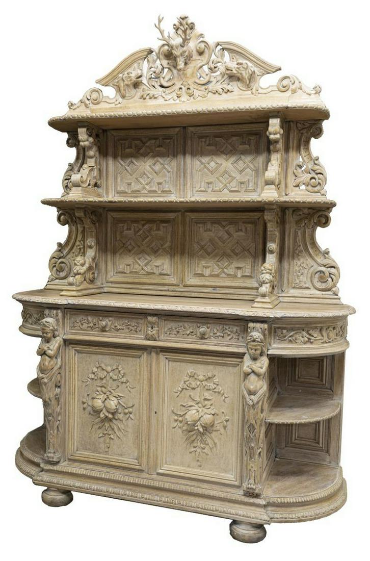 FRENCH CARVED OAK HUNT SIDEBOARD STAG CREST: French carved oak hunt sideboard, late 19th c., in a later whitewashed finish, split pediment with stag crest flanking by hunting dogs, open shelves on scrolled corbels, geometric paneled back, lower 