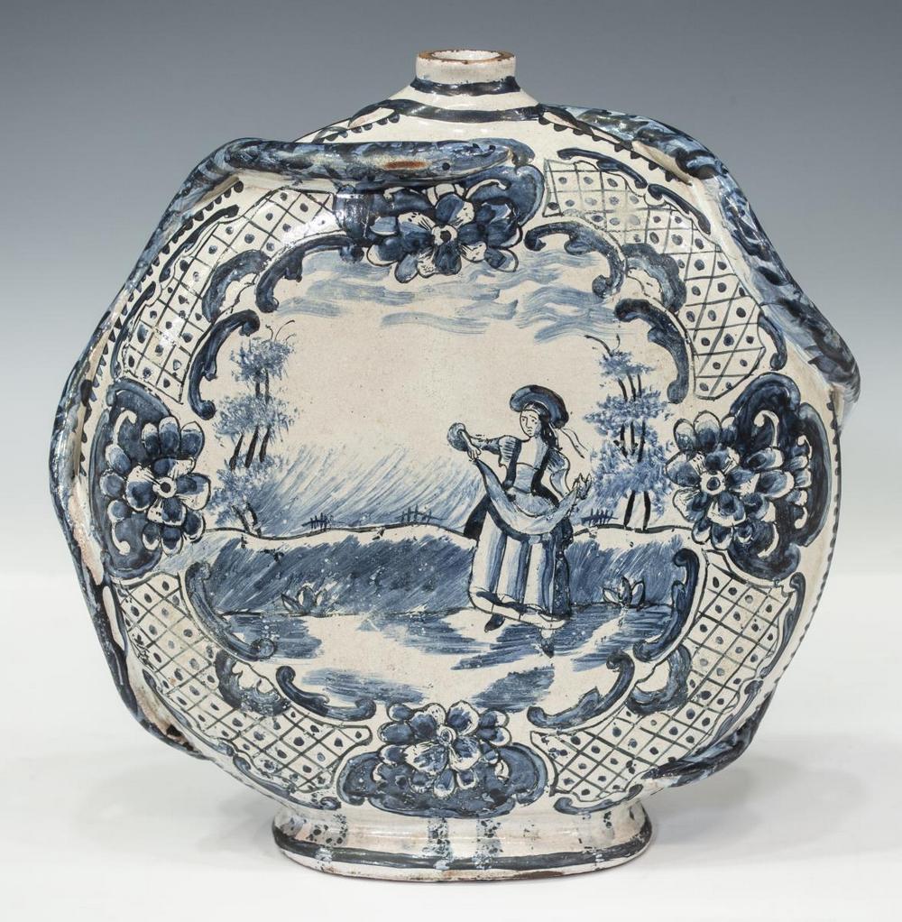 DELFT B&W FAIENCE POTTERY MOON FLASK, LATE 18TH C.: Delft blue and white faience pottery moon flask, late 18th c., narrow circular spout, applied stylized serpents, one side with a figure in landscape reserve, reversed by floral spray, some wear at rim