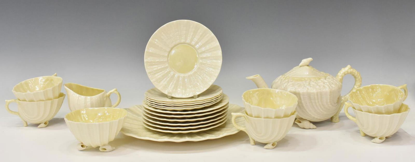 22) IRISH BELLEEK NEPTUNE YELLOW PORCELAIN TEA SET: (lot of 22) Irish Belleek Neptune porcelain tea set, c.1926-1946, with seashell and coral forms, third period black marks, including: (1) teapot, approx 5.25"h, (1) creamer, approx 3 1/8"h, (1) open s