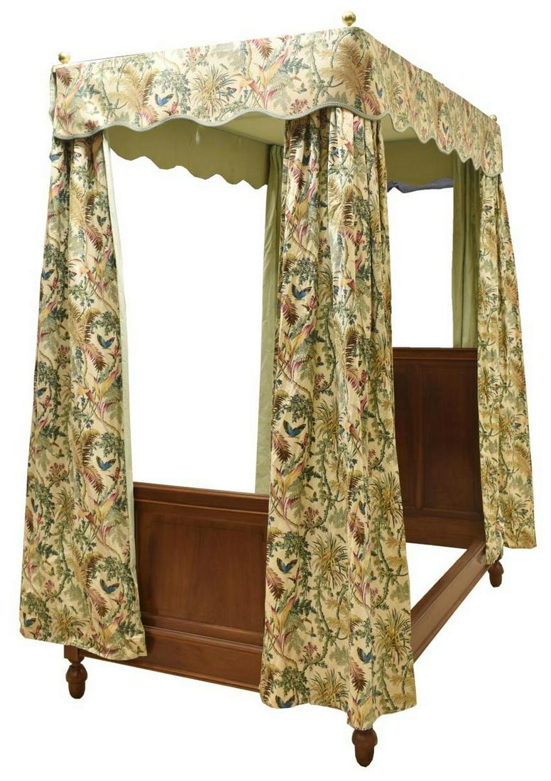 FRENCH WALNUT CANOPY BED WITH FLORAL CURTAINS: French walnut canopy bed, 20th c., with three panels to footboard and headboard, columnar bed posts, on wooden stretchers, poles lead upward to fabric canopy, four curtains fall from corners of canopy