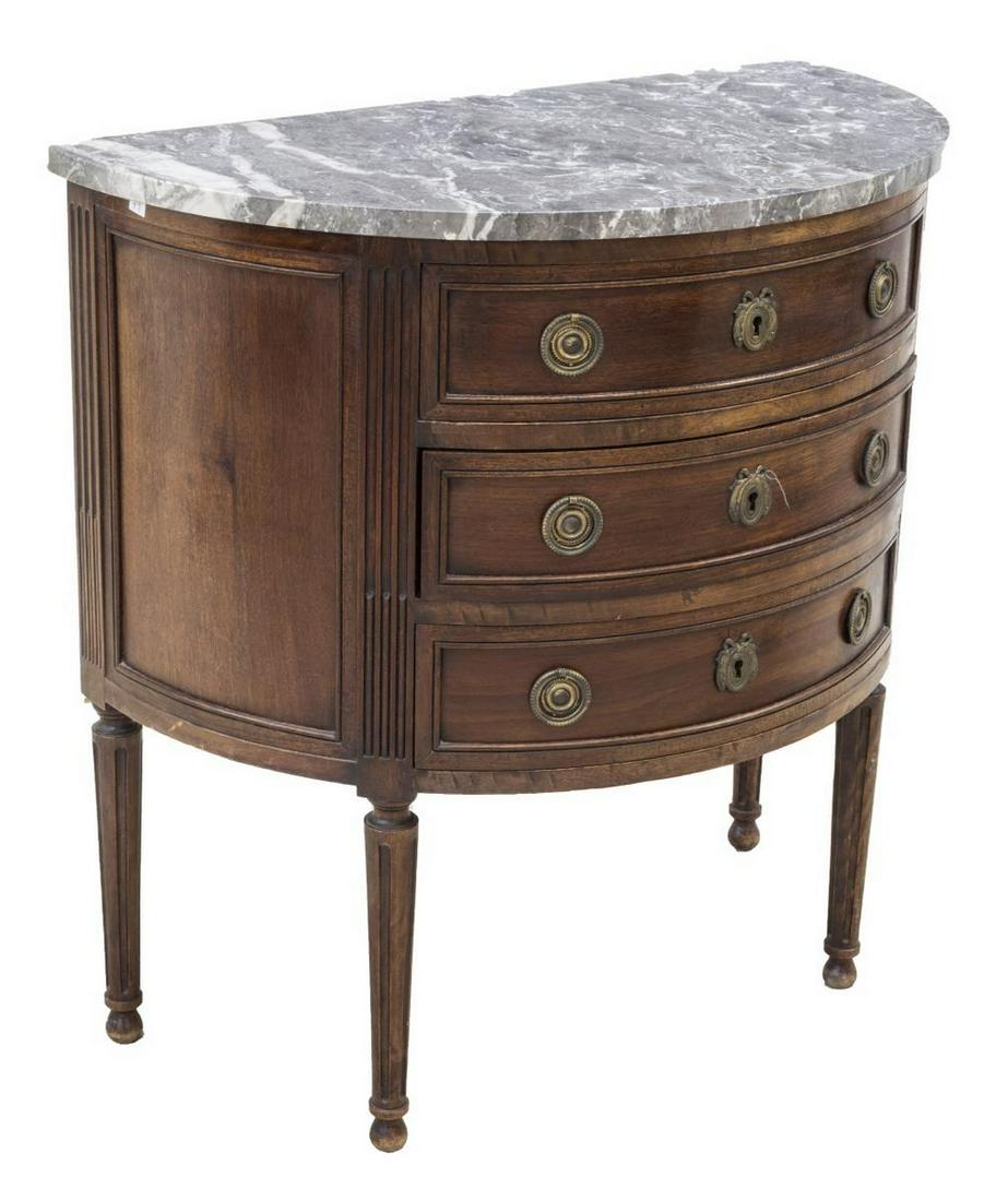 FRENCH LOUIS XVI STYLE DEMILUNE MARBLE-TOP COMMODE: French Louis XVI style mahogany commode, early 20th c., demilune marble top, over corresponding case, three drawers with ring pulls, rising on fluted tapered cylindrical legs, chip to back corner of m