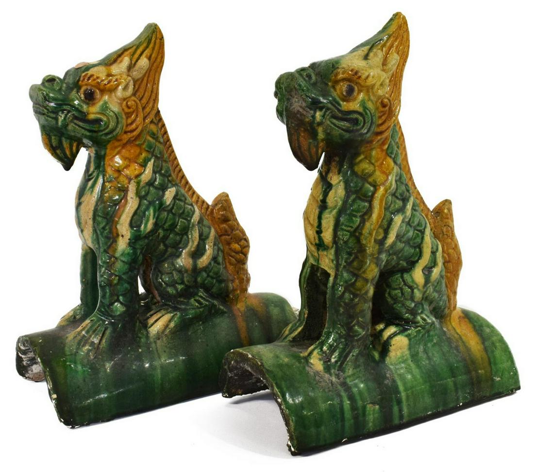 (2) CHINESE CULTURE REVOLUTION PERIOD ROOF TILES: (pair) Chinese glazed ceramic foo dog/ guardian lion roof tiles, each in a green and yellow glaze, depicted seat atop curved roof tiles, each retaining partial wax seal, approx 11.75"h, 4.25"w, 9"d, 1