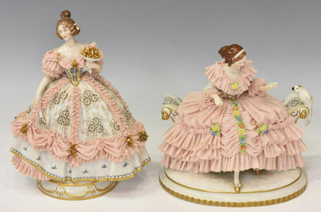 (2) GERMAN DRESDEN LACE PORCELAIN FIGURES: (lot of 2) German Dresden lace porcelain figures, with blue underglaze crowned N mark, including: (1) seated lady, in pink lace dress with applied flowers, feeding a parrot, approx 7.75"h, 7"w, 5.75"d