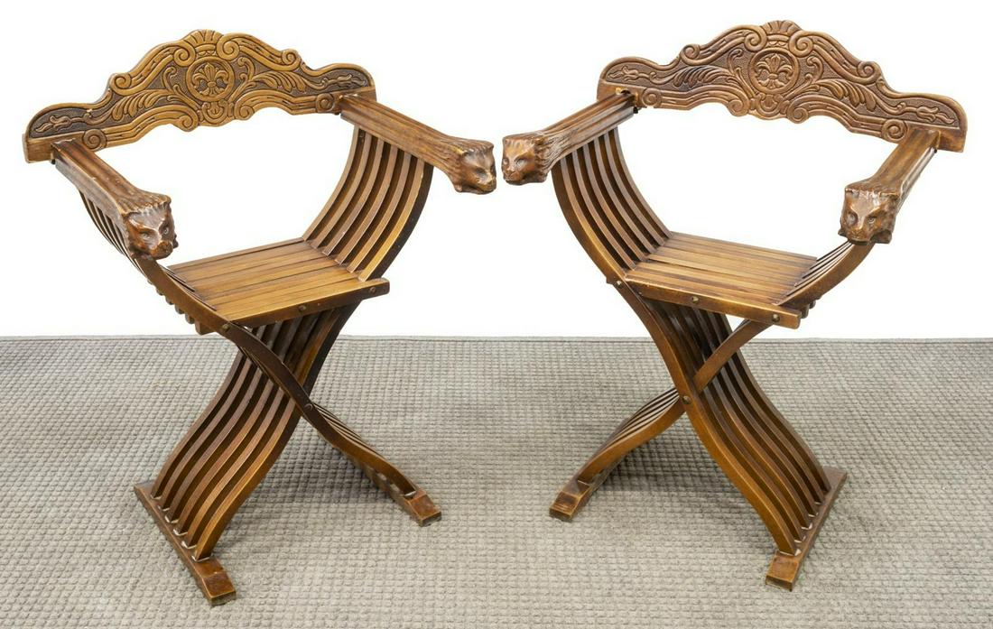 (2) ITALIAN CARVED SAVONAROLA CHAIRS: (pair) Italian Savonarola chairs, early 20th c., each having shell and foliate carved splat, over the folding curule frame, two arms terminating in lion head handholds, approx 33.75"h, 26"w, 20"d Star