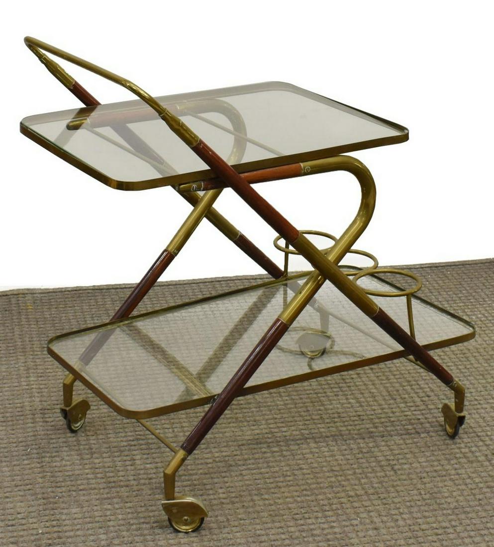 ITALIAN BRASS & WOOD TWO-TIER SERVICE BAR CART: Italian brass and wood service cart, 20th c., wood frame in x-form having two glass shelves with brass fittings, handle to one side, three bottle holders on lower shelf, approx 29"h, 27.25"w, 17"d Sta