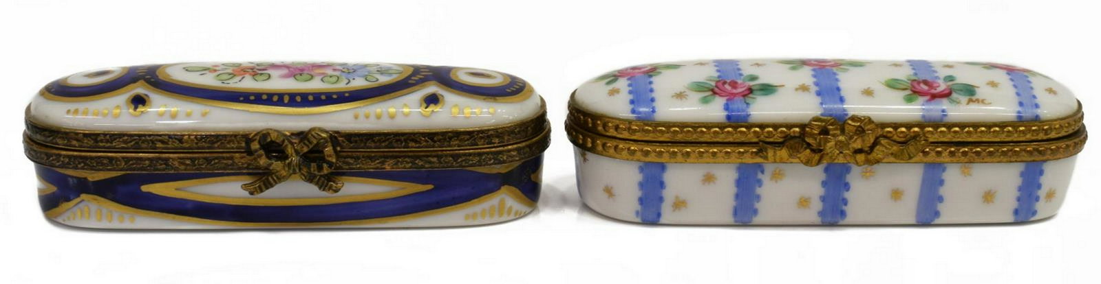 (2) FRENCH LIMOGES MINIATURE PORCELAIN TRINKET BOX: (lot of 2) French Limoges miniature porcelain trinket boxes, oblong form, parcel gilt, with hand-painted floral motifs, largest: approx 0.75"h, 3"l, 1.25"w; 0.25lbs total Start Price: $50.00