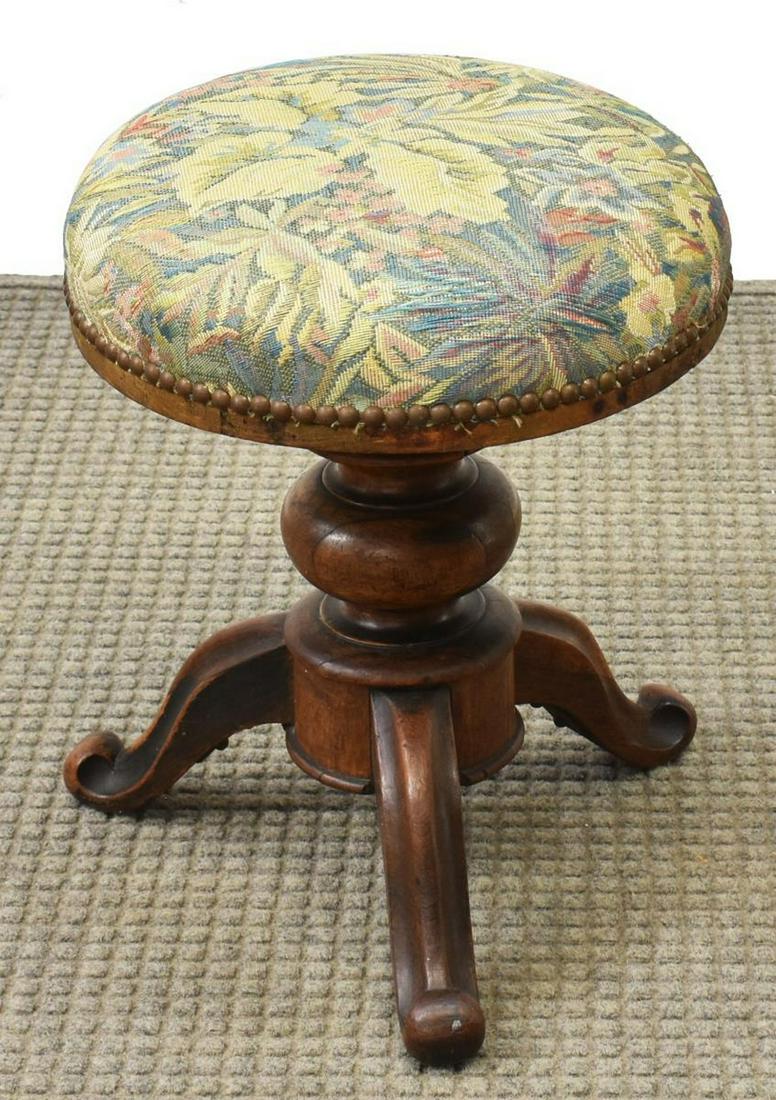 ITALIAN FLORAL UPOLSTERED WALNUT PIANO STOOL: Italian piano stool, 19th c., walnut frame, with upholstered seat in floral pattern, with nail head border, rising on three scrolled legs, approx 17"h, 14"diam Start Price: $50.00