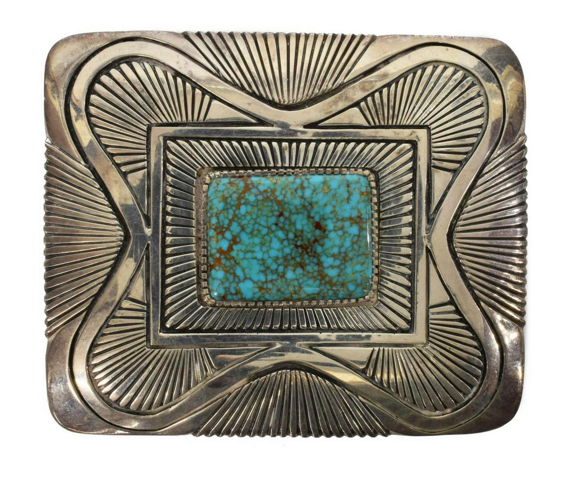 NATIVE AMERICAN STERLING & TURQUOISE BELT BUCKLE: Native American sterling belt buckle, marked verso GZN (Gibson Nez, Navajo), having central bezel-set rectangular Nevada Blue turquoise, stamped with parallel lines, around undulating border, approx 3
