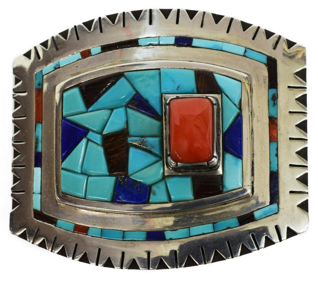 KATHRYN WALLACE NAVAJO INLAID SILVER BUCKLE: Native American silver inlaid buckle, Kathryn Wallace (Navajo), worked silver buckle having multi-stone inlays and stepped design, featuring a large coral cabochon to the left, approx 1.75"h, 2.25"w, 