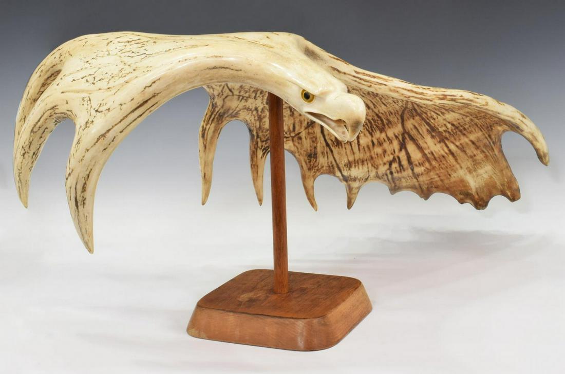 STANLEY HILL (MOHAWK) CARVED MOOSE ANTLER EAGLE: Mohawk figural carved moose antler, Eagle in Flight, signature to top, Stan Hill (Stanley R. Hill, Mohawk, Ontario, New York, 1921-2003) dated 1980, resting on wood stand, accompanied by original rece