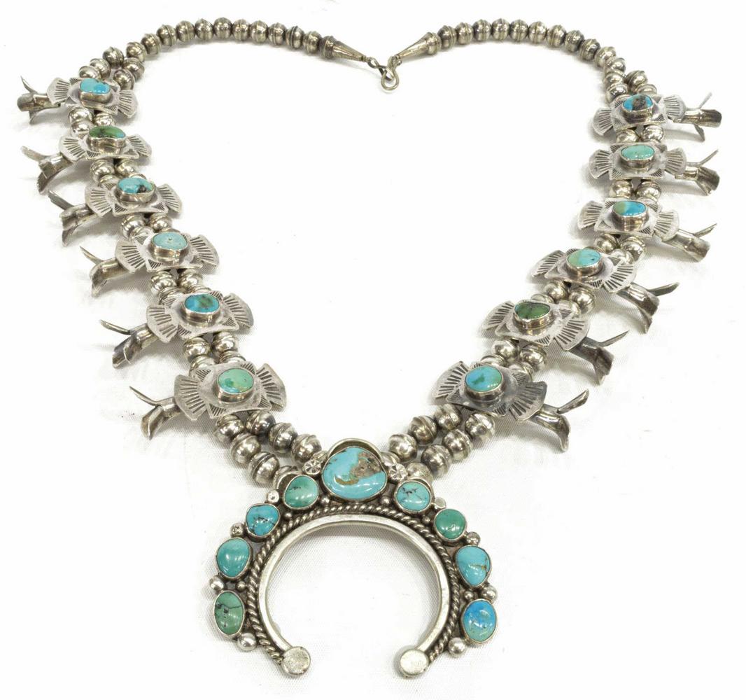 NATIVE AMERICAN STERLING SQUASH BLOSSOM NECKLACE: Native American sterling silver squash blossom necklace, two strands of bench beads, twelve turquoise-set stamped blossoms, central naja with nine turquoise cabochons, twisted wirework, marked sterlin