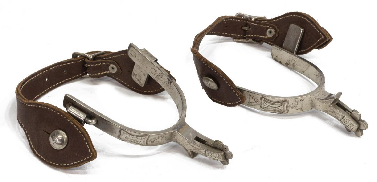 J.R McCHESNEY NOCONA PERIOD SILVER OVERLAY SPURS: J.R. McChesney Nocona period silver overlay spurs, five point 1" star rowels, leather straps, inside yoke approx 3.1/8"w, 3.1/8"d Start Price: $250.00