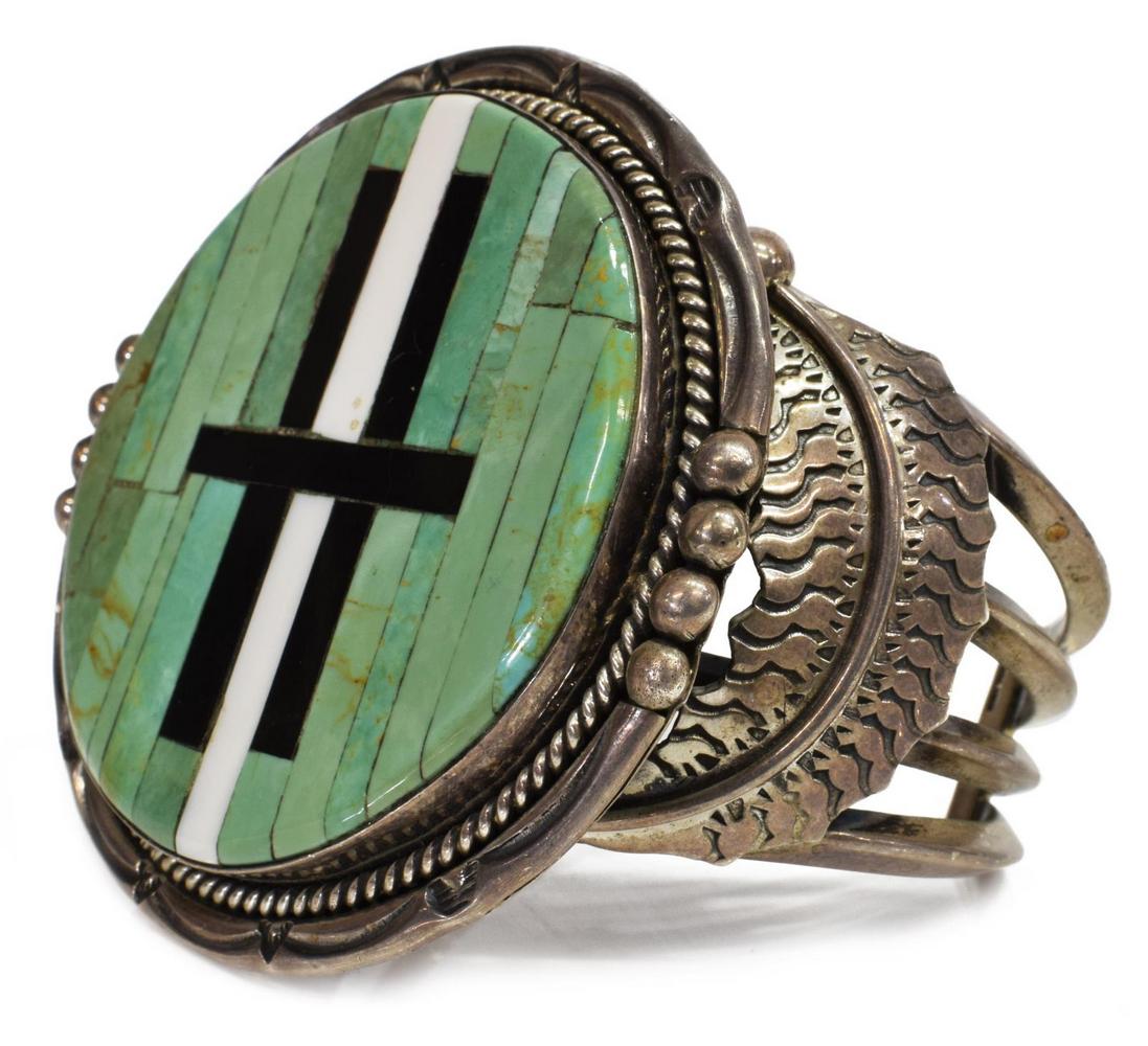 JEANETTE DALE NAVAJO STERLING INLAID CUFF BRACELET: Native American sterling silver inlaid cuff bracelet, signed Dale (Jeanette Dale, Navajo), large round circular plaque with inlaid turquoise, jet and other strips, beaded and twist bezel on an open wo