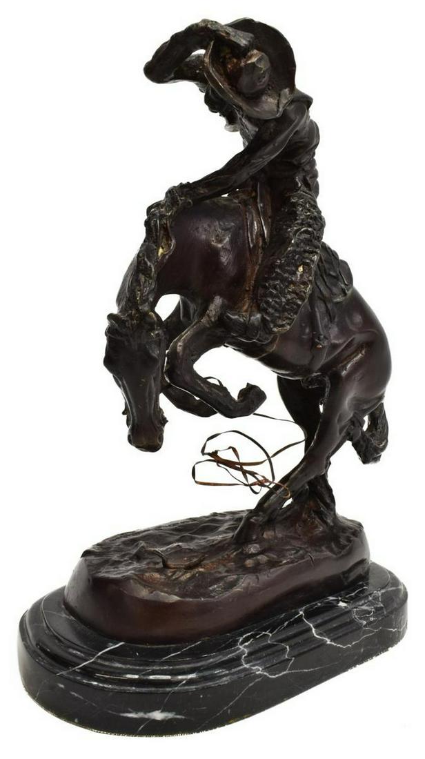 WESTERN BRONZE AFTER REMINGTON, 'THE RATTLESNAKE': Patinated bronze sculpture on marble, "The Rattlesnake," after the original 23" high 1905 sculpture created by Frederic Remington (American, 1861-1909), bronze: approx 9.5"h, 8"w. 4.75"d, overall with