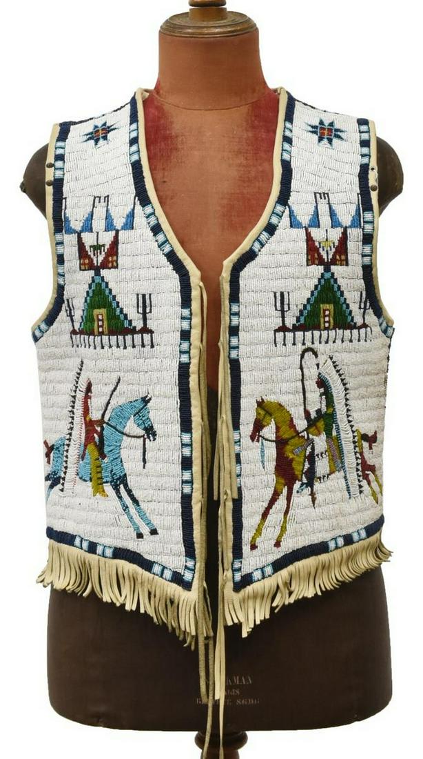 NATIVE AMERICAN SIOUX PICTORIAL FULLY BEADED VEST: Magnificent Native American fully beaded leather vest, Sioux, c.1920s, with two chiefs on horseback, one with Winchester rifle and one with coup stick, fully decorated and beaded back, leather tie clo