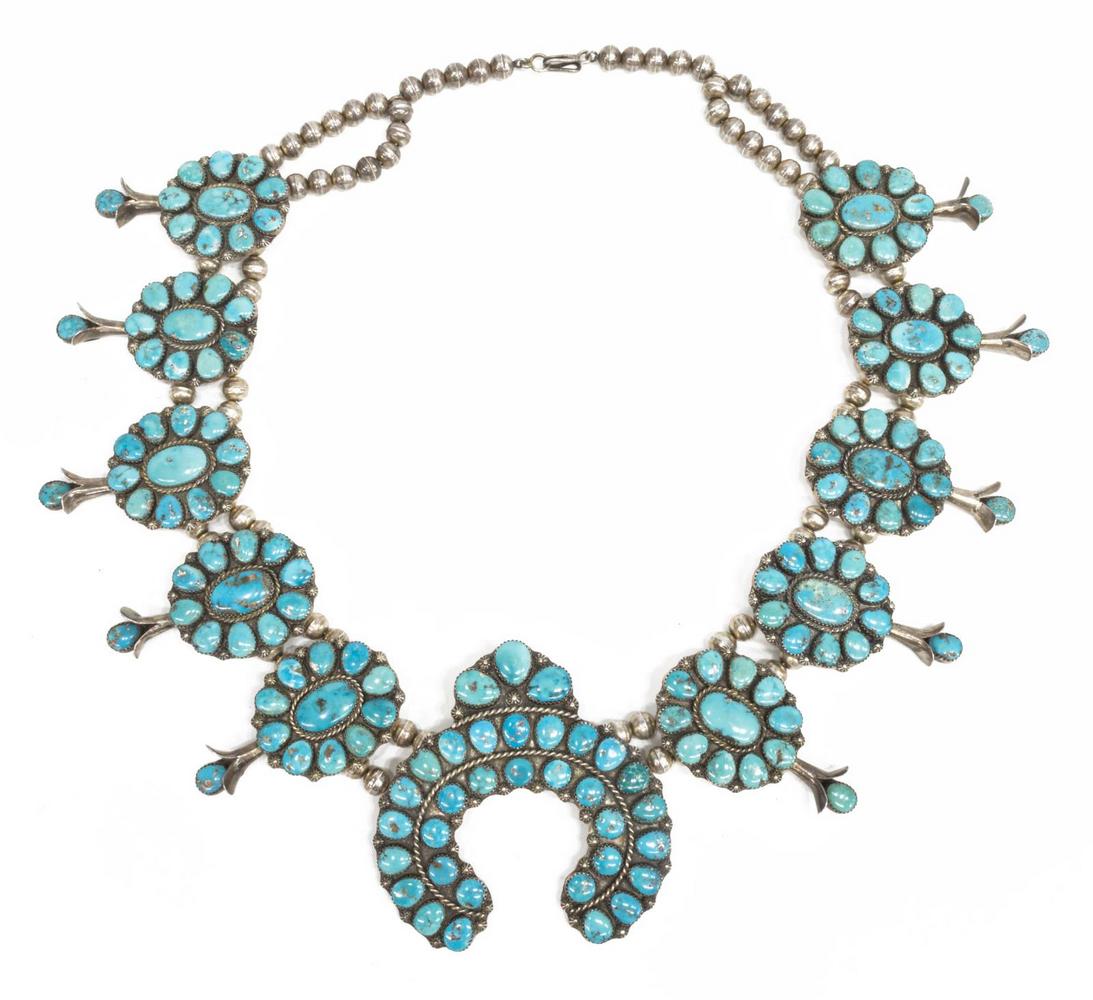 NATIVE AMERICAN TURQUOISE SQUASH BLOSSOM NECKLACE: Native American silver (content unknown) squash blossom necklace, c.1970s, two strands of bench beads, ten blossoms and central naja all set with Morenci turquoise cabochons, hook closure, approx 28"l
